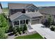 Beautiful home with stone accents, a covered porch, attached two car garage, and well-manicured landscaping at 6193 Saddle Bow Ave, Parker, CO 80134