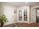 Hallway featuring hardwood floors, a house plant, a front door, French doors to the office and another room entrance at 6193 Saddle Bow Ave, Parker, CO 80134