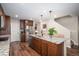 The kitchen has dark cabinets, stainless steel appliances, granite counters, and an island that has seating for meals at 6193 Saddle Bow Ave, Parker, CO 80134
