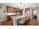 Modern kitchen with granite countertops, stainless steel appliances, dark wood cabinets and a large island at 6193 Saddle Bow Ave, Parker, CO 80134