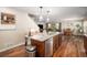Kitchen island features granite countertops, a dishwasher, bar stool seating and is part of an open concept living space at 6193 Saddle Bow Ave, Parker, CO 80134