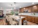 Kitchen featuring dark cabinets, granite countertops, bar seating, stainless steel appliances and view of the outdoor space at 6193 Saddle Bow Ave, Parker, CO 80134