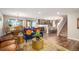 Open-concept living area with a view of the dining room, kitchen, and staircase, perfect for modern living at 6193 Saddle Bow Ave, Parker, CO 80134