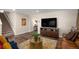 Comfortable living room with staircase, hardwood floors, large television and an open floor plan at 6193 Saddle Bow Ave, Parker, CO 80134
