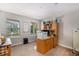 The home office has an oak built-in desk, carpeted floor, and windows that provide natural light and neighborhood views at 6193 Saddle Bow Ave, Parker, CO 80134