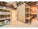 Unfinished basement with visible wood framing and utilities, offering potential for customization at 12441 W Virginia Ave, Lakewood, CO 80228
