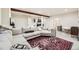 Finished basement area with cozy sectional sofa and stylish decorative rug at 12441 W Virginia Ave, Lakewood, CO 80228