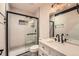 Sleek bathroom featuring a modern shower with glass door, vanity, and stylish fixtures at 12441 W Virginia Ave, Lakewood, CO 80228