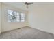 Bright bedroom features plush carpet and a window with natural light and a ceiling fan at 12441 W Virginia Ave, Lakewood, CO 80228
