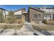 Modern brick home with unique architectural details, landscaped front yard, and stylish curb appeal at 12441 W Virginia Ave, Lakewood, CO 80228