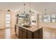 Island kitchen features granite countertops and stainless appliances in a naturally lit open space at 12441 W Virginia Ave, Lakewood, CO 80228