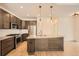 Bright kitchen features stainless steel appliances, a center island, and wooden floors at 12441 W Virginia Ave, Lakewood, CO 80228