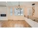 Open living room featuring wood floors, fireplace, modern lighting and large windows at 12441 W Virginia Ave, Lakewood, CO 80228