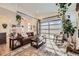 Bright living room featuring a unique garage door-style window and stylish decor at 12441 W Virginia Ave, Lakewood, CO 80228