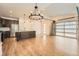Open concept living space with island kitchen, stainless steel appliances, and unique roll-up door at 12441 W Virginia Ave, Lakewood, CO 80228