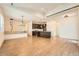 Open-concept floor plan with modern lighting, island kitchen, and wood flooring at 12441 W Virginia Ave, Lakewood, CO 80228