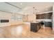 Spacious living area with a modern fireplace, island kitchen, and wood floors at 12441 W Virginia Ave, Lakewood, CO 80228