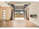 Spacious open-concept living area with modern fireplace, roll-up glass door and hardwood floors at 12441 W Virginia Ave, Lakewood, CO 80228