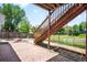 Backyard with a brick patio and stairs leading up to the deck at 8879 Apache Plume Dr, Parker, CO 80134