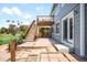 Backyard featuring a deck, brick patio, and side door to the home at 8879 Apache Plume Dr, Parker, CO 80134