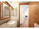 Bathroom featuring a granite vanity and a doorway view of a fireplace at 8879 Apache Plume Dr, Parker, CO 80134