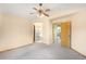 Spacious bedroom showcasing ceiling fan, ensuite bath, and doorway leading into another room at 8879 Apache Plume Dr, Parker, CO 80134