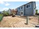 Exterior view of home featuring a deck, backyard, brick patio, and many windows at 8879 Apache Plume Dr, Parker, CO 80134