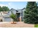 Charming two-story home offers mature trees, a well-manicured lawn, and covered entrance at 8879 Apache Plume Dr, Parker, CO 80134
