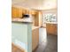 Bright kitchen with tile flooring, stainless steel microwave, and plenty of wooden cabinets at 8879 Apache Plume Dr, Parker, CO 80134