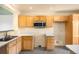 Functional kitchen featuring abundant cabinetry, stainless steel microwave, and neutral countertops at 8879 Apache Plume Dr, Parker, CO 80134