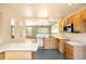 Bright eat-in kitchen features ample cabinetry, recessed lighting and views to an adjacent living area at 8879 Apache Plume Dr, Parker, CO 80134