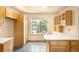 Kitchen featuring tile flooring, wood cabinets, and ample counter space, creating a functional cooking area at 8879 Apache Plume Dr, Parker, CO 80134