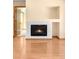 Cozy living room featuring a modern fireplace and sleek wood-look flooring at 8879 Apache Plume Dr, Parker, CO 80134