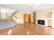 Open-concept living room featuring fireplace and staircase at 8879 Apache Plume Dr, Parker, CO 80134