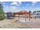 Backyard with a wooden pergola and a trampoline at 23469 E Briarwood Pl, Aurora, CO 80016
