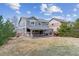 Spacious backyard featuring a covered patio with stone accents and comfortable seating area, perfect for outdoor relaxation at 23469 E Briarwood Pl, Aurora, CO 80016