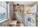 Luxurious shower featuring unique stone-look tile and a built-in bench at 23469 E Briarwood Pl, Aurora, CO 80016