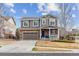 Charming two-story home with stone accents, inviting front porch, and well-manicured landscaping at 23469 E Briarwood Pl, Aurora, CO 80016