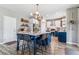 Bright kitchen featuring a large center island with seating and modern pendant lighting at 23469 E Briarwood Pl, Aurora, CO 80016