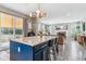 Bright kitchen island with seating and views into the living room and backyard at 23469 E Briarwood Pl, Aurora, CO 80016