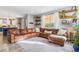 Spacious living room featuring a comfortable sectional sofa, large window, and stylish decor at 23469 E Briarwood Pl, Aurora, CO 80016
