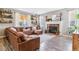 Inviting living room with a large sectional, wood-burning fireplace, and charming decor at 23469 E Briarwood Pl, Aurora, CO 80016