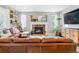 Cozy living room with stone fireplace and lots of natural light, perfect for relaxing at 23469 E Briarwood Pl, Aurora, CO 80016