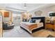Inviting main bedroom with decorative accents, stylish furnishings, and a tray ceiling at 23469 E Briarwood Pl, Aurora, CO 80016