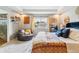 Bright and airy main bedroom with stylish decor, a comfy chair, and large windows at 23469 E Briarwood Pl, Aurora, CO 80016