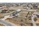 Aerial view of the lovely home surrounded by a white fence and spacious lot in a neighborhood at 16665 Kenuil St, Brighton, CO 80603