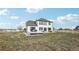 Spacious home back exterior with a deck and a large grassy area, perfect for outdoor activities at 16665 Kenuil St, Brighton, CO 80603