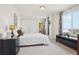 Bright bedroom featuring a cozy bed, a large window, and a black dresser for storage at 16665 Kenuil St, Brighton, CO 80603