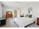 Spacious bedroom featuring a cozy bed, vintage dresser, and a door leading to other rooms at 16665 Kenuil St, Brighton, CO 80603