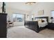 Spacious bedroom with a large window, black furniture set, and cozy carpet, providing a comfortable retreat at 16665 Kenuil St, Brighton, CO 80603